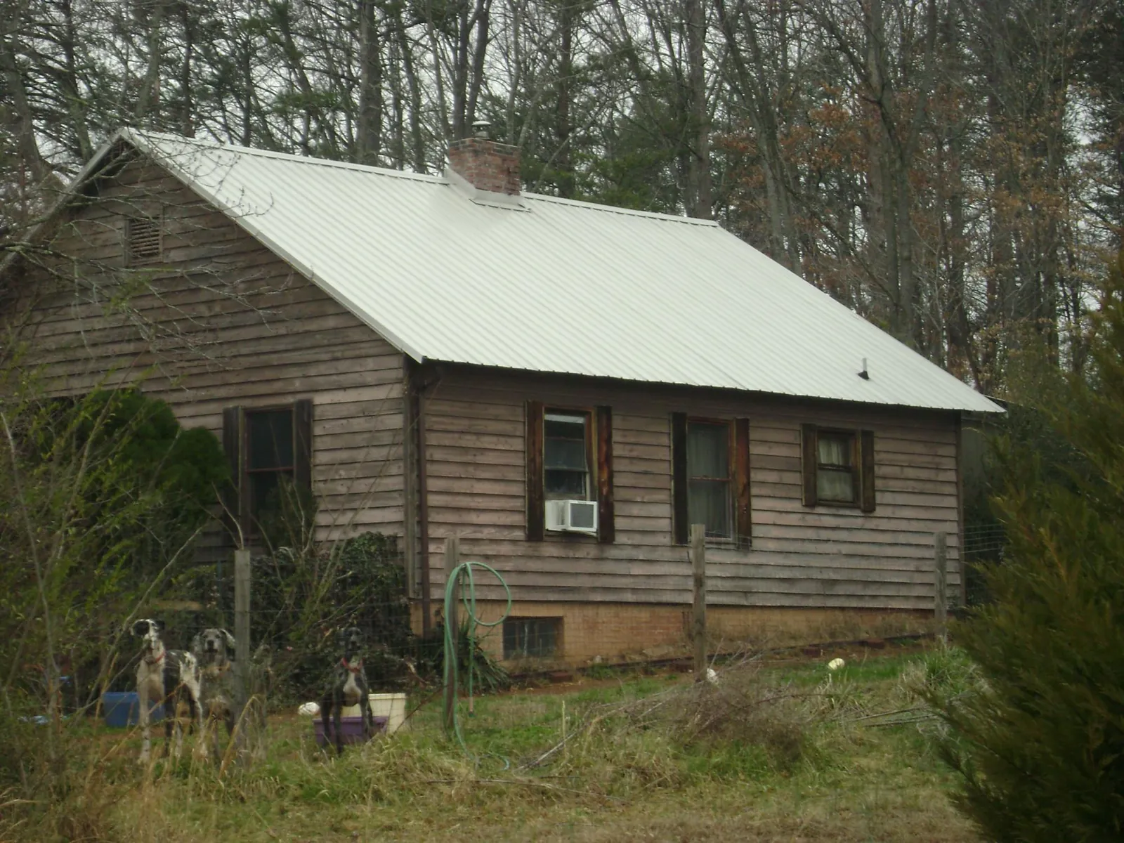 White metal roof on an old wood sided farmhouse, from a Metal Roof Installation job in New Bavaria
